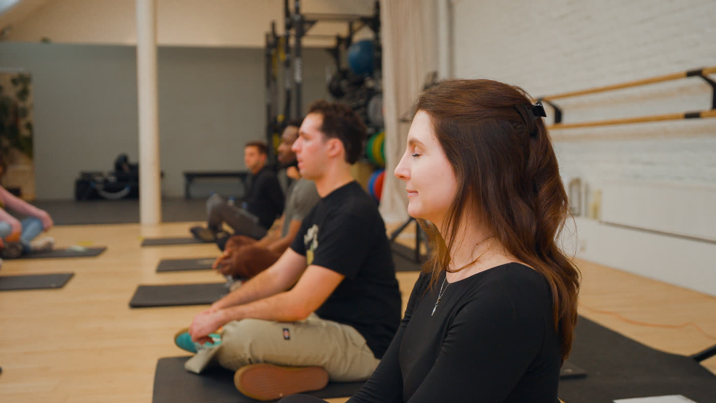 A participant seated with eyes closed during the cooldown.