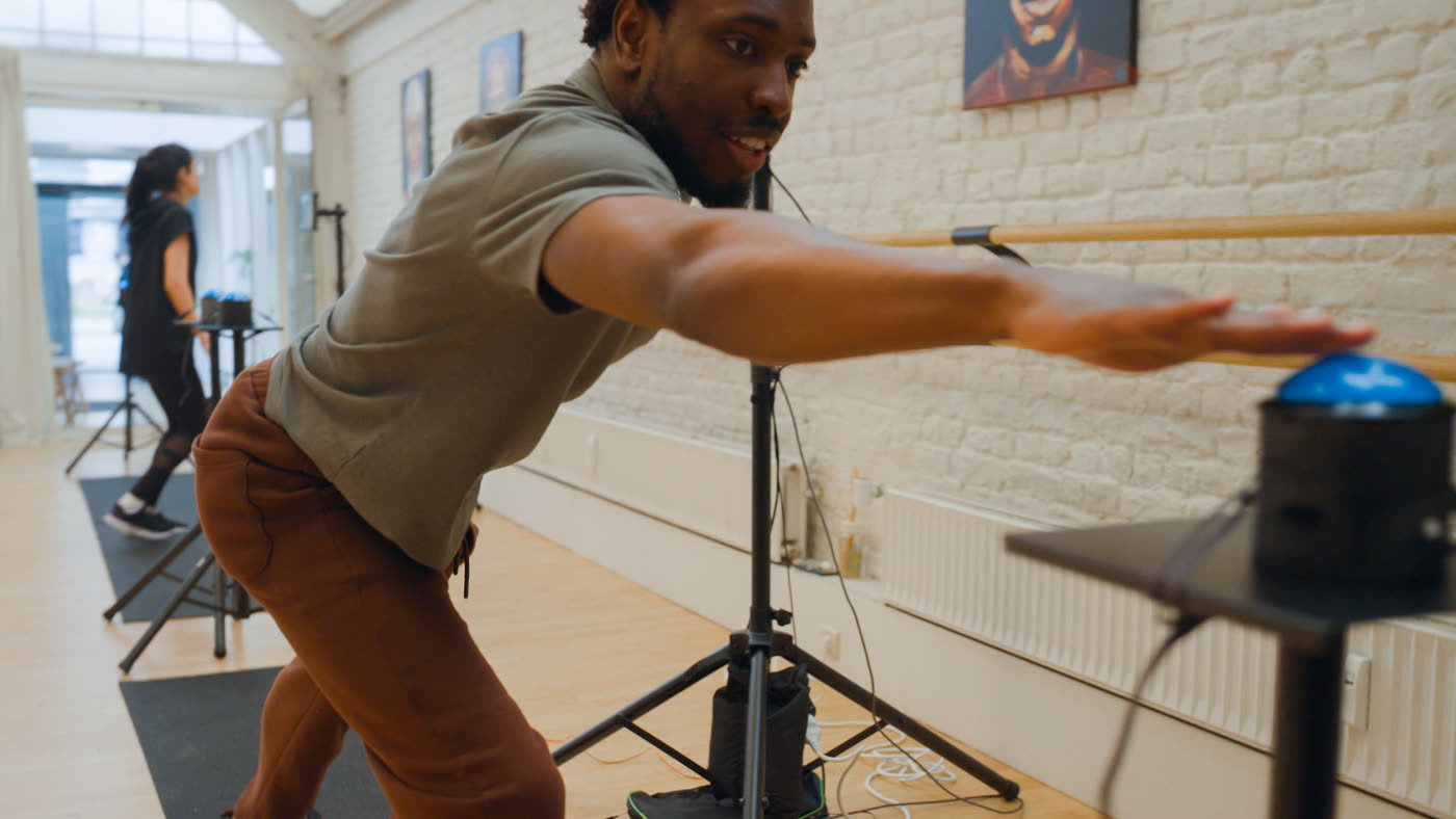 A participant performing a dynamic movement at a Cogniflux Lab station.